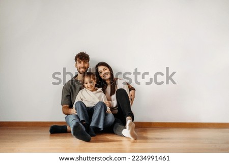 Happy Caucasian family in their new empty home 