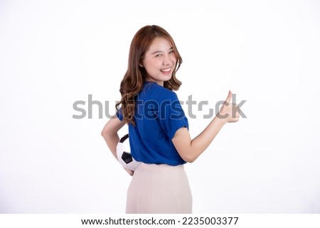 Asian woman smiling in blue t-shirt holding football to cheering the soccer game isolated on white screen background.