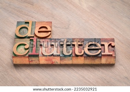 declutter - word abstract in vintage letterpress wood type stained by color inks, minimalism, business and lifestyle concept