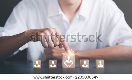 HRM or Human Resource Management ,Strategic planning for success through people business development concept by choosing professional leaders employee competency Teamwork, man pointing at wooden block Royalty-Free Stock Photo #2235038549