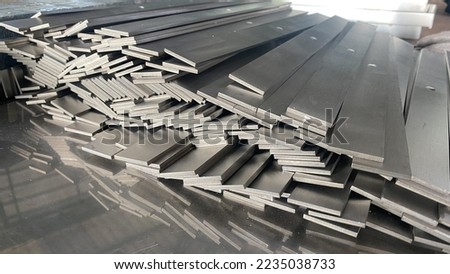Stack of stainless steel flat bar of background.  Royalty-Free Stock Photo #2235038733