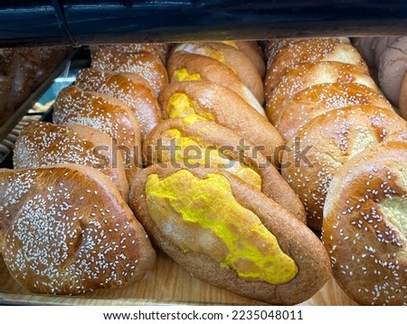 View of three different types of Mexican sweet bread including the traditional cocol de anis.