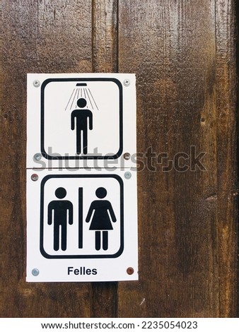 Male and female toilet sign, restroom sign on wood background