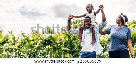 Portrait of enjoy happy family african american father and mother with little girl child smiling and play having fun moments good time in room at home