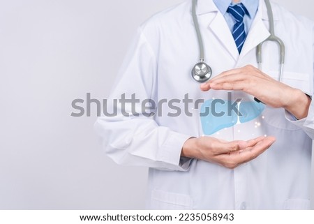 doctor in uniform hands holding liver organ virtual icon, hepatitis vaccination, liver cancer treatment. Health checkup concept. Royalty-Free Stock Photo #2235058943