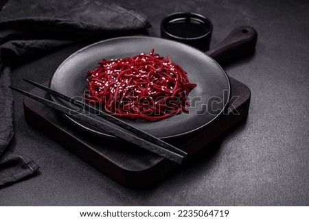 Tasty spicy Korean beet with spices and herbs on a dark concrete background. Asian food