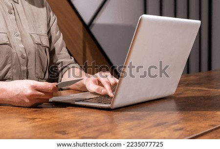 Paying with bank debit card through internet, shopping online with laptop computer, buying virtually. Virtual payment concept. High quality photo