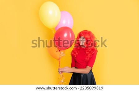 cheerful kid with party balloon on yellow background