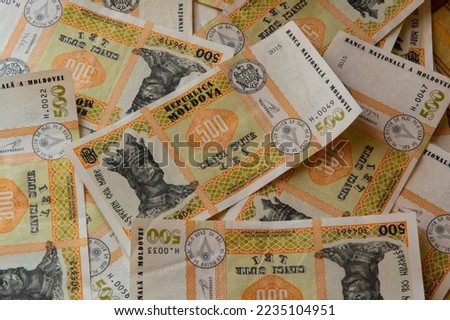 close-up: Moldovan leu banknotes of 500 lei lying randomly on a table captured from the top