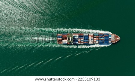 cargo logistics container ship sailing in green sea to import export goods and distributing products to dealer and consumers across worldwide, by container ship Transport business service. top view  Royalty-Free Stock Photo #2235109133