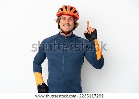 Young blonde cyclist man isolated on white background pointing up a great idea