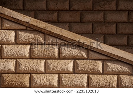 Brick vintage textured wall with diagonal shapes in an abstract photo great for background. Lights and shadows.