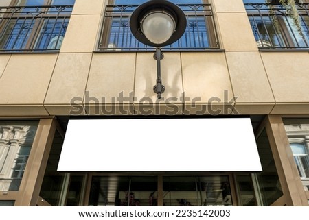 White horizontal rectangular empty signboard mockup on office, cafe, store, shop facade. Low angle view