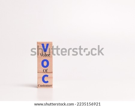 Alphabets VOC written on wooden cubes. Voice of customer. Consumer feedback concept.