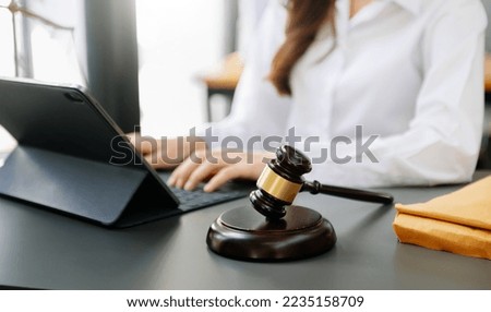 Female lawyer in the office with brass scale on black table. justice and law concept in morning light

