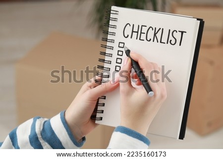 Woman filling Checklist with pen indoors, closeup. Space for text