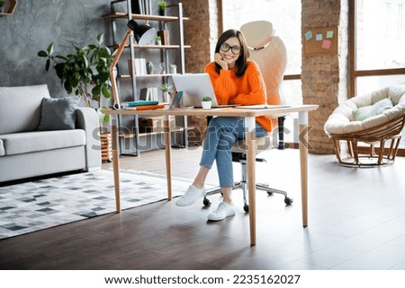 Photo of positive dreamy lady wear orange sweater having pause working modern device indoors workshop workplace workstation