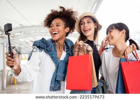 Group of diversity woman shows an ecstatic expression and take a selfie after shopping mall with shopping bag and bright smile. E-commerce and Shopaholism. Big surprise last years sale.