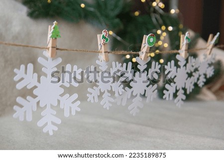 garland of white snowflakes on clothespins