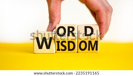 Wisdom word symbol. Concept words Wisdom word on wooden cubes. Businessman hand. Beautiful yellow table white background. Business and wisdom word concept. Copy space.
