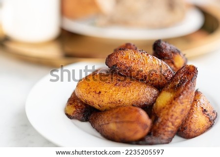 A closeup of fried sweet plantains on a plate  Royalty-Free Stock Photo #2235205597