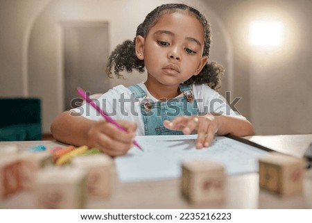 Girl, homework and writing on paper, learning and homeschool with math, education and knowledge at table in home. Latino child or student in brazil with concentration, school work and study in house