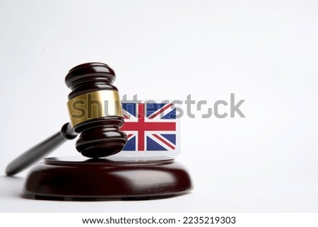 Legal law concept image, judge gavel and United Kingdom flag isolated on white background with copy space, close-up. selective focus image