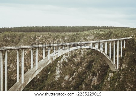 Experience the thrill of a lifetime from the world's highest bungee jumping spot on Bloukrans Bridge, standing at a breathtaking 216m high in South Africa. Dive into the ultimate adrenaline rush. Royalty-Free Stock Photo #2235229015