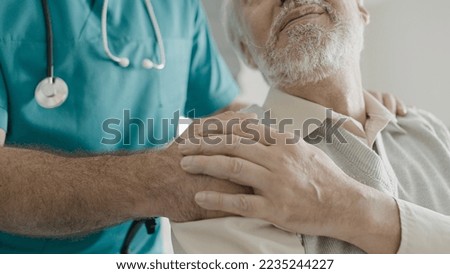 Caring medical practitioner supporting senior pensioner in rehabilitation center Royalty-Free Stock Photo #2235244227