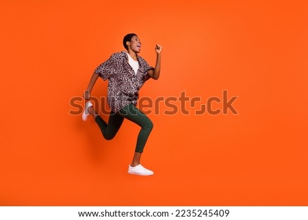 Full body profile photo of active person look empty space hurry rush isolated on orange color background Royalty-Free Stock Photo #2235245409