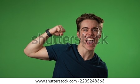 Portrait of amazed young man 20s shocked, saying WOW. Handsome guy surprised isolated on solid green screen background 