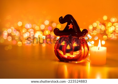 Halloween pumpkin with candlelight and bokeh background