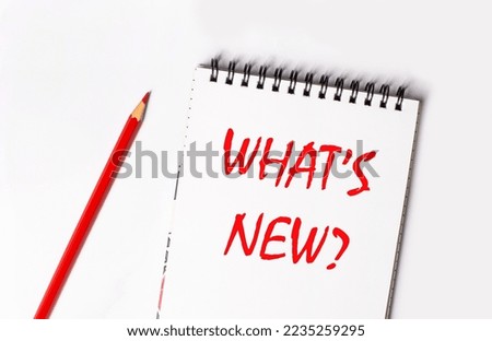 Red pencil and white notepad with the text WHAT'S NEW Royalty-Free Stock Photo #2235259295