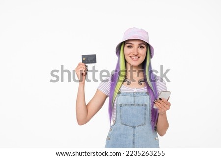 Young caucasian hipster teenage woman girl with tattoo holding credit card for internet banking, e-commerce, online transactions, cashback, payments isolated in white background