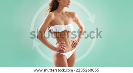 Beautiful woman with slim and sporty body in swimwear having arrows along her stomach and legs. Fat lose, liposuction and cellulite removal.