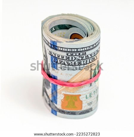 Scrolled stack of dollar bills on white background