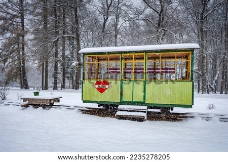Perfect example of Horse Drawn Tram in Baldone. Latvia.  First horse-drawn tram car was recreated. Snowing.