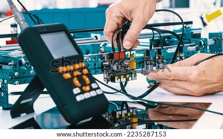 Assembling and adjust the electronics instrument for precision physical measurements Royalty-Free Stock Photo #2235287153