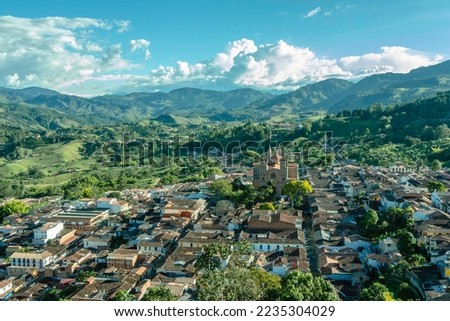 Wide panorama of the superb village (pueblo) of Jerico, antioquia, Colombia, with a blue sky and the Andes Mountains in the background. Picture taken from El Morro El Salvador. Royalty-Free Stock Photo #2235304029