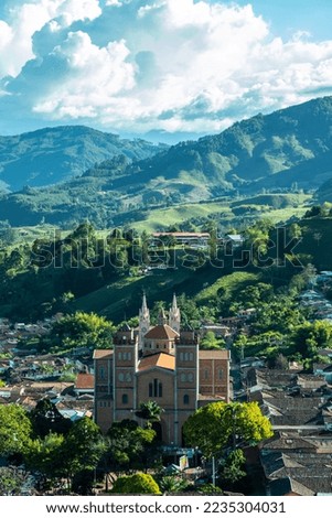 Aerial view of the brick church of Jerico, Antioquia, Colombia. Blue sky and the Andes Mountains in the background. Picture taken from El Morro El Salvador.