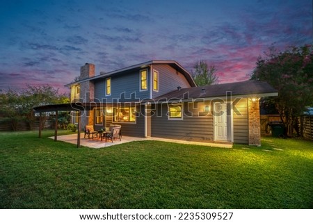 A back yard with a patio at sunset Royalty-Free Stock Photo #2235309527