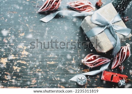 Christmas background with wrapped presents, ornaments and vintage toy truck over rustic background. Overhead table top view. Copy space available.