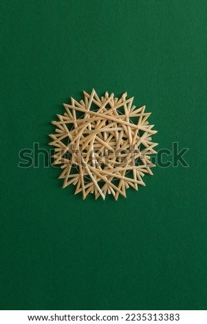 Snowflakes are made of straw on a green background. Christmas decor. Top view	