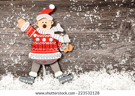 Funny bear over wooden background with snow