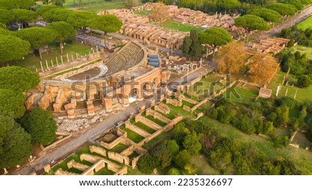Aerial view on the Roman theatre of Ostia Antica, a large archaeological site, close to the modern town of Ostia. The ancient Roman Amphitheater is located in Rome, Italy. Royalty-Free Stock Photo #2235326697