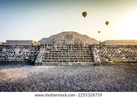 Pyramid of Sun in Teotihuacan (nahuatl name) and air hot ballons , ancient Mesoamerican city in Mexico, located in the Valley of Mexico, near of Mexico City Aztecs  Royalty-Free Stock Photo #2235328759