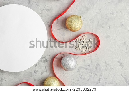 Composition with blank card, Christmas decorations and ribbon on grunge background