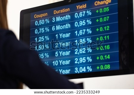 Financial advisor looks at the rising rates. Close-up computer monitor with yields and mortgage rates. Financial business, mortgage loans, debt financing and banking industry.