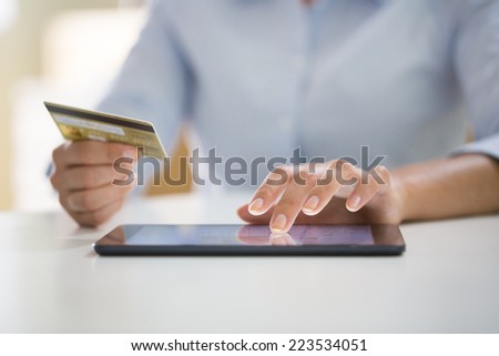 Woman is shopping online with tablet pc
