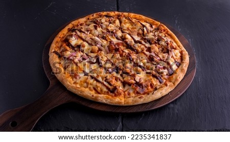 BBQ CHICKEN pizza isolated on cutting board top view on dark background italian fast food Royalty-Free Stock Photo #2235341837